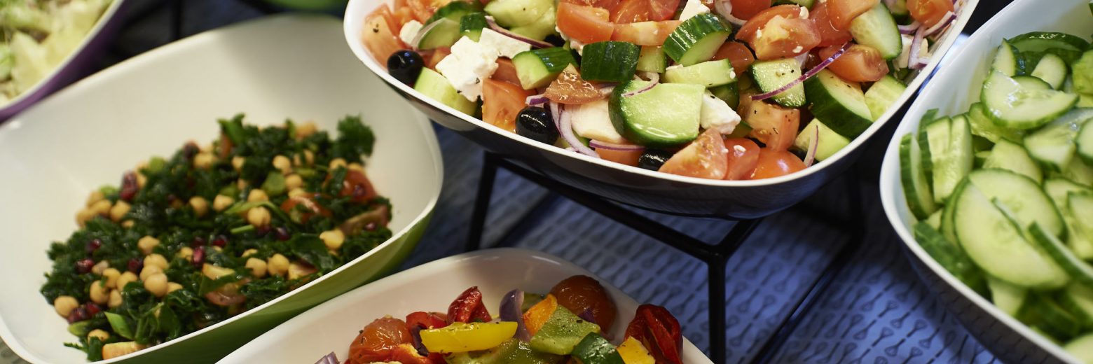 different types of salads and cut up veg