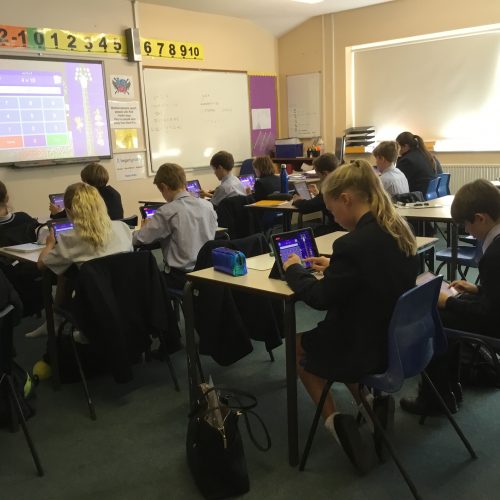 children sat in a classroom doing their work