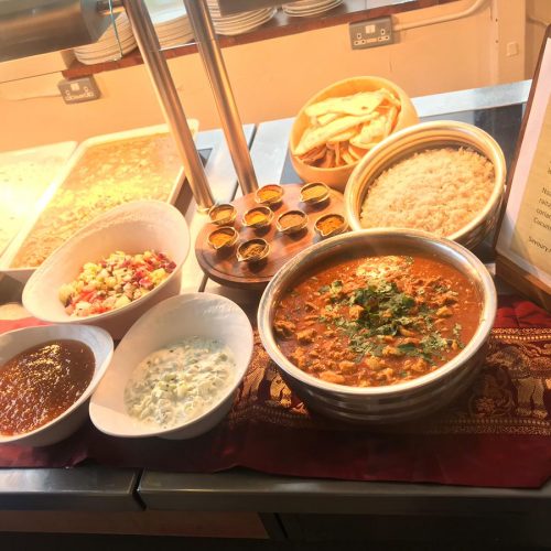 Bowls of Indian curry, rice and dips