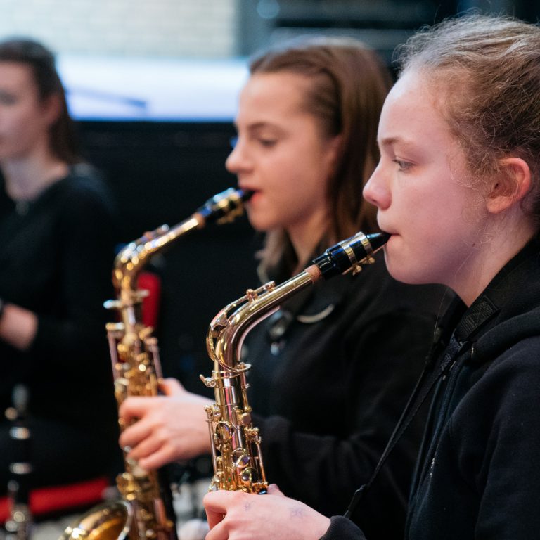 girls playing saxophones