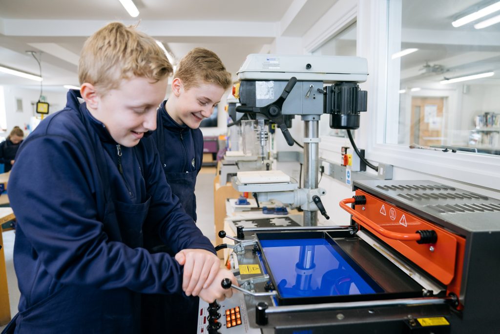 student with laser cutter