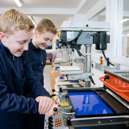 student with laser cutter