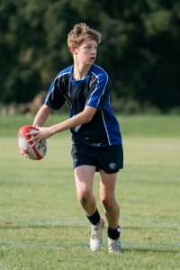 Boy holding rugby ball