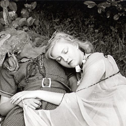 girl laying on a person with a deer mask