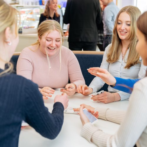 sutdents working and playing card games