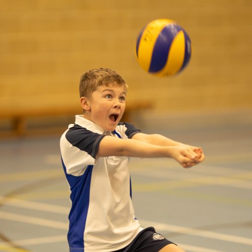 boy hitting a ball with his palms