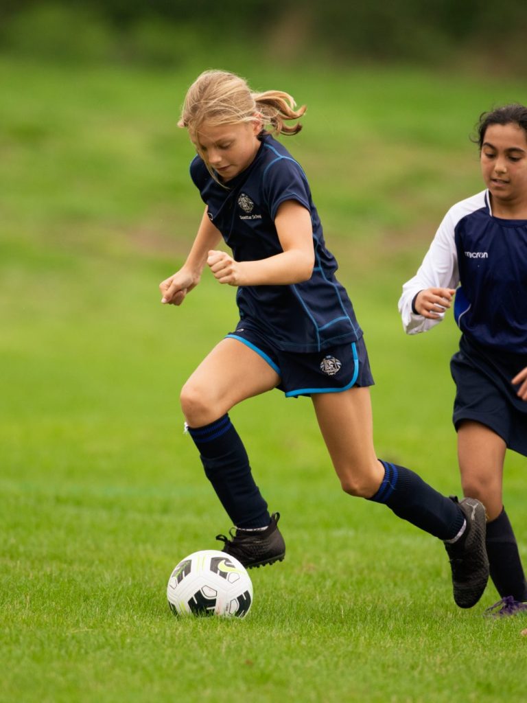 Girl kicking ball