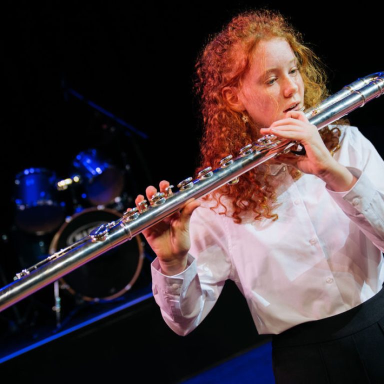 student playing the flute