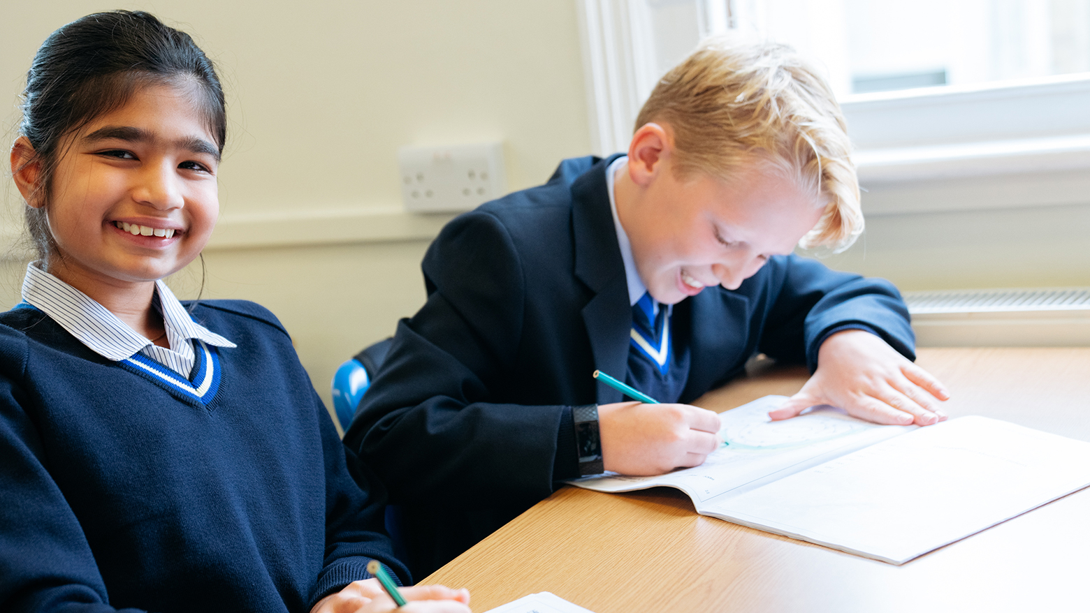 Student writing on a booklet