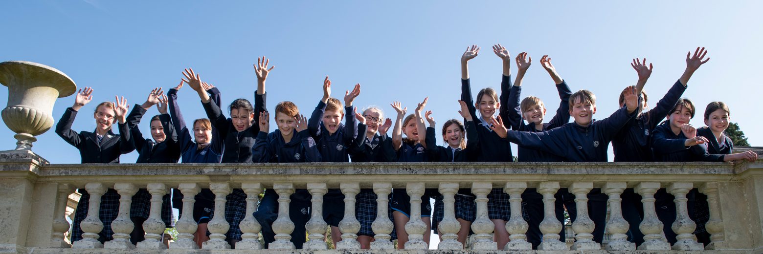 Students waving their hands in the air