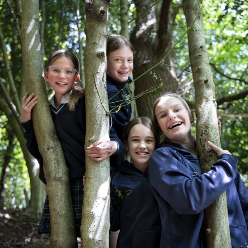 girls stood between trees