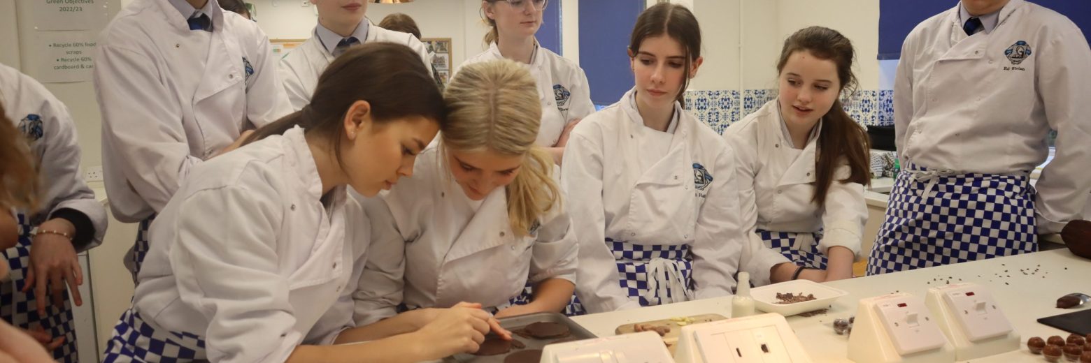 Students laying out chocolate on trays