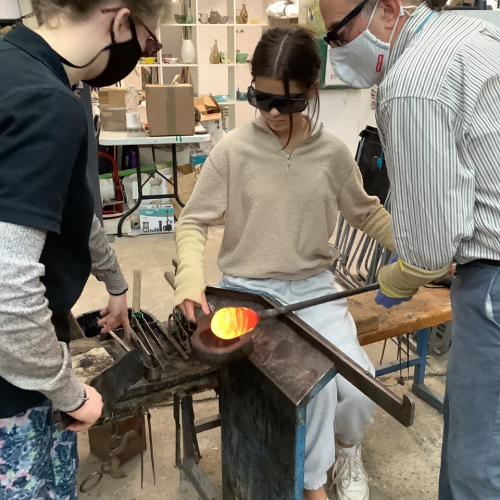 Students in a glassmaking workshop